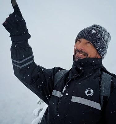 a man in a black jacket and a hat
